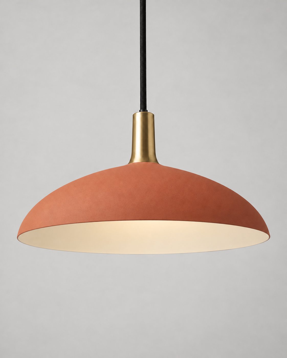 Forma pendant light in terracotta with a brass neck and black suspension cord