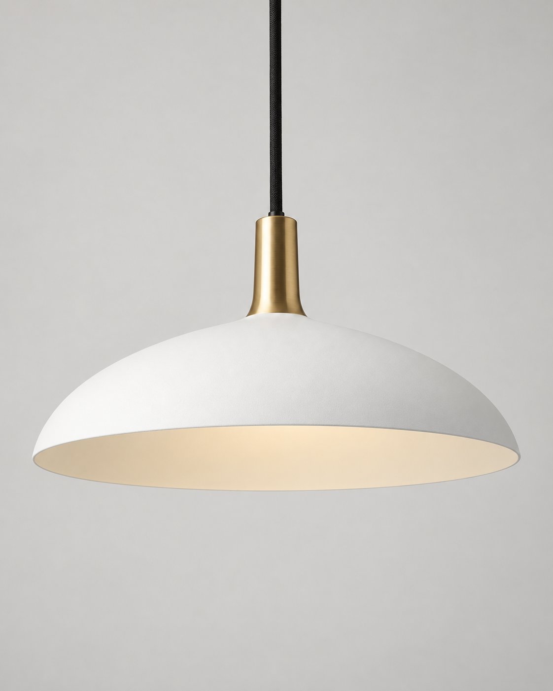 Forma pendant light in chalk with a brass neck and black suspension cord