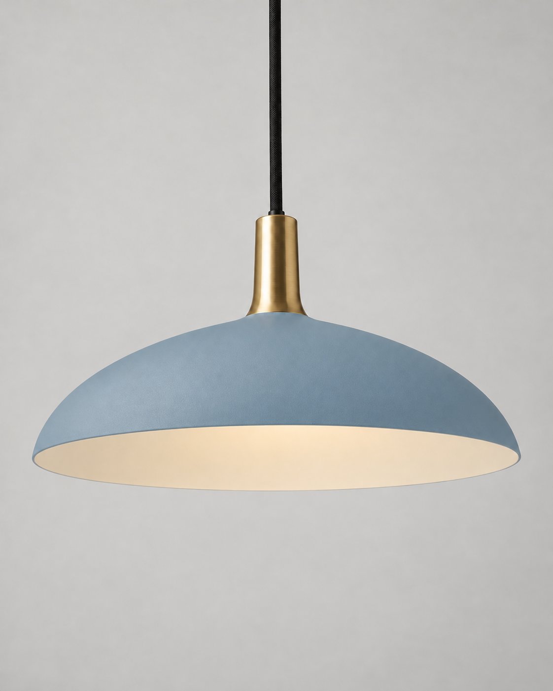 Forma pendant light in dusty blue with a brass neck and black suspension cord