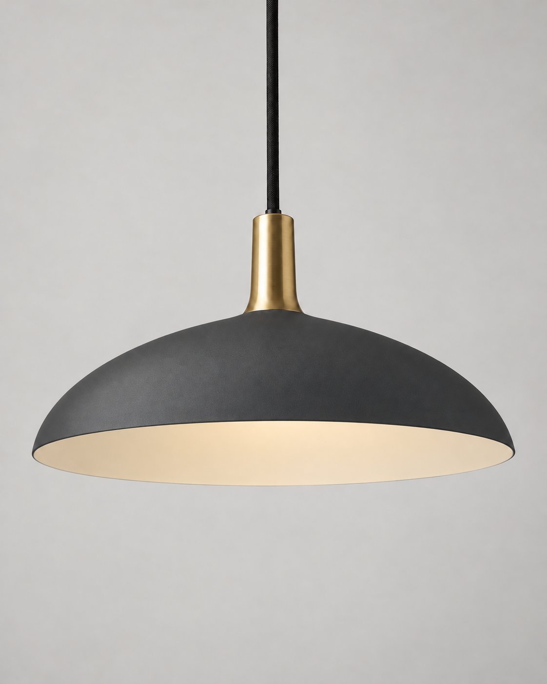 Forma pendant light in charcoal with a brass neck and black suspension cord